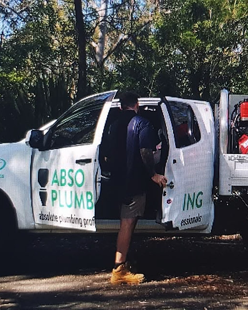 ABSO Plumbing's wrapped white ute with the ABSO PLUMBING logo on the door